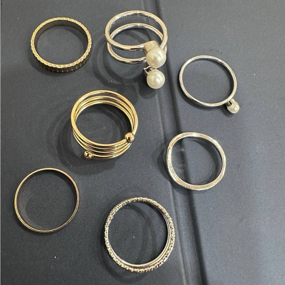 Bundle of seven rings golden and silver